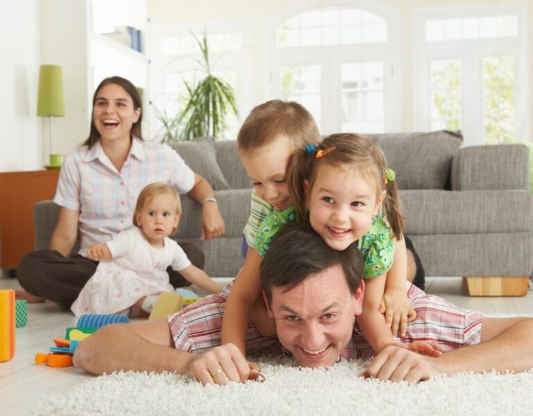 COMFORT family playing in living room shutterstock 53173996 e1550015867174